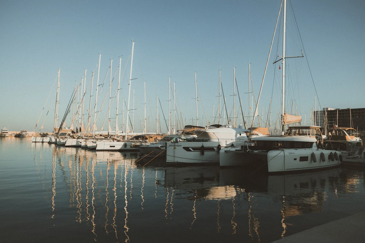 Sailboats and their reflections in a marina